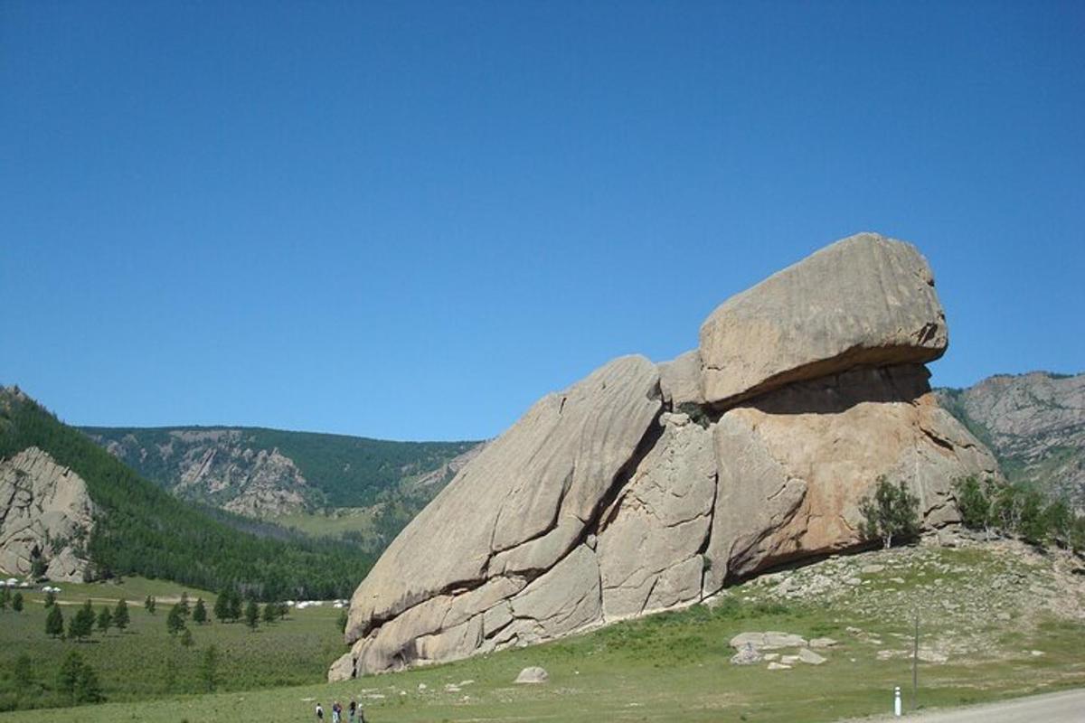 a large rock on the side of a road
