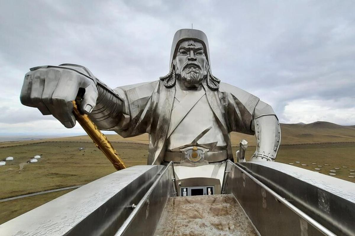 a large statue of a man holding a horn