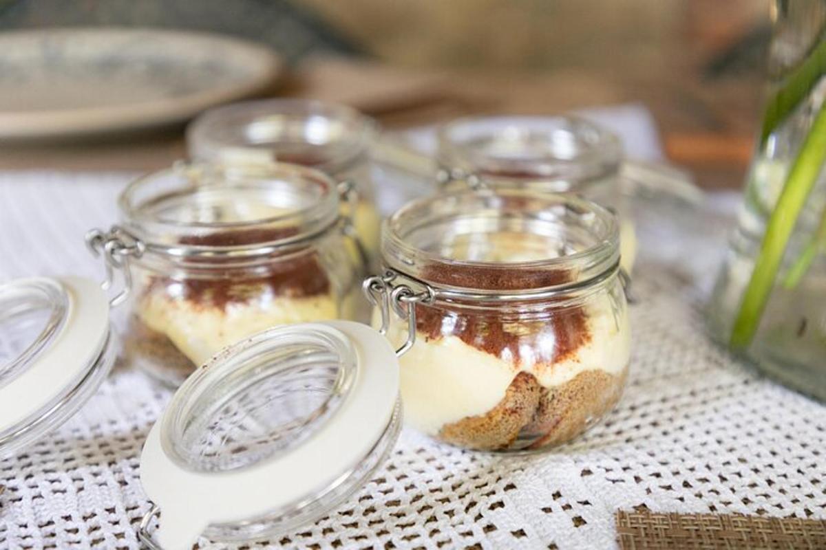 a table with four glass jars with food in them