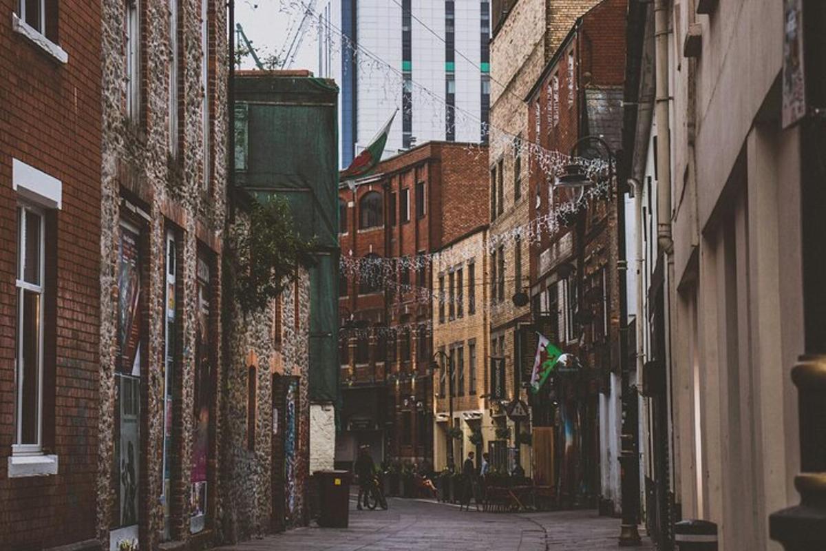 an alley between buildings with people walking down it