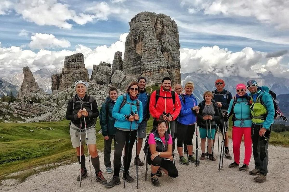 a group of people posing for a picture on a mountain