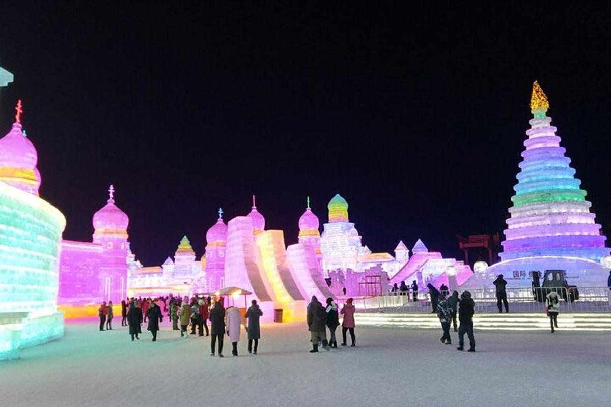 a group of people walking in front of ice sculptures