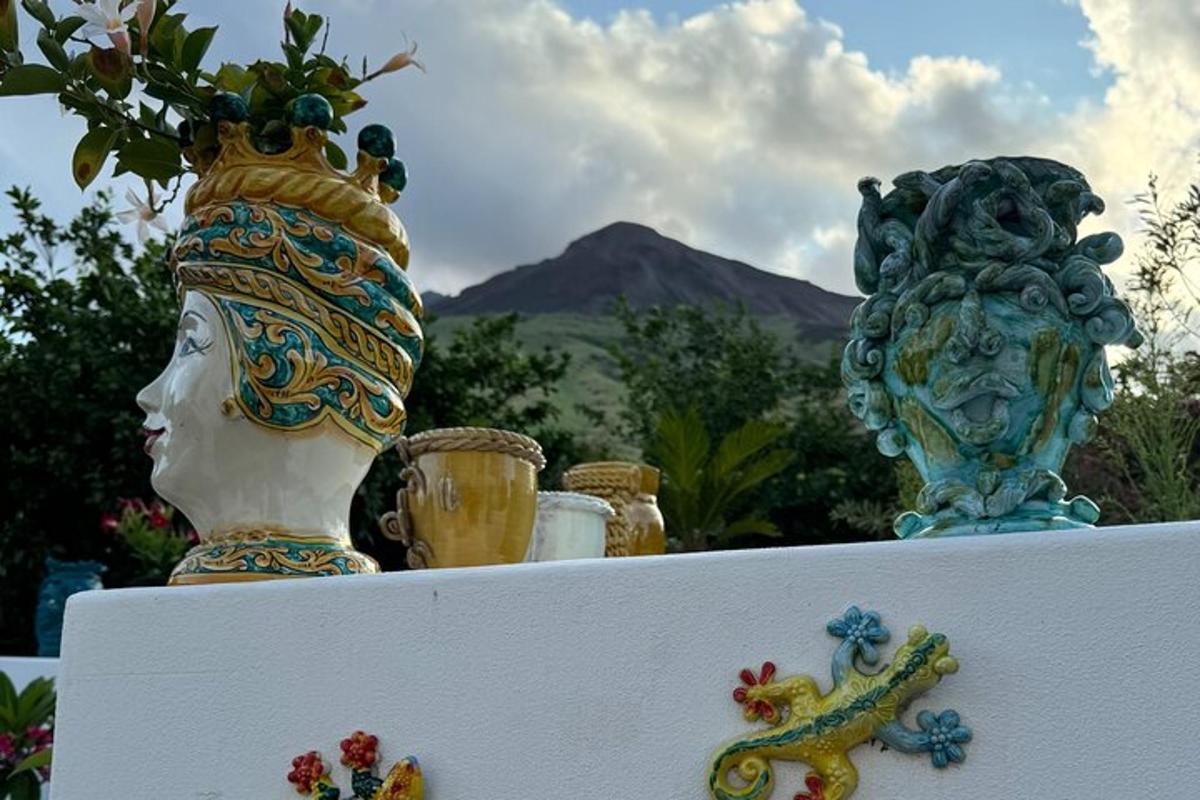 two vases sitting on top of a white shelf with flowers