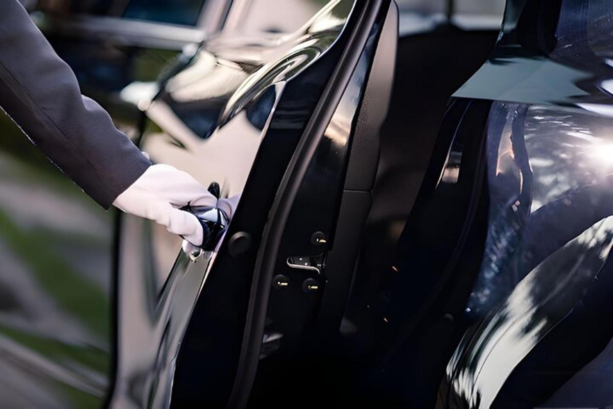 a person in a white glove unlocking a car door