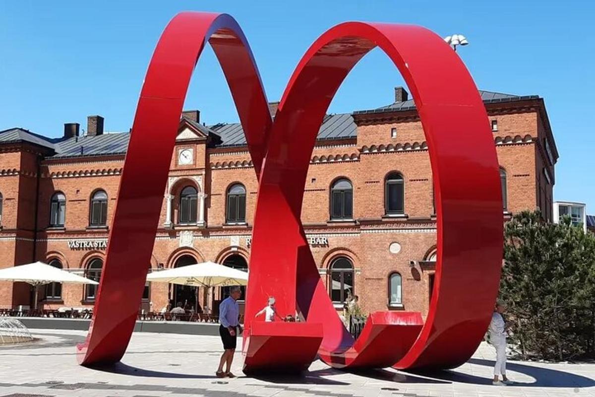 a large red sculpture in front of a building
