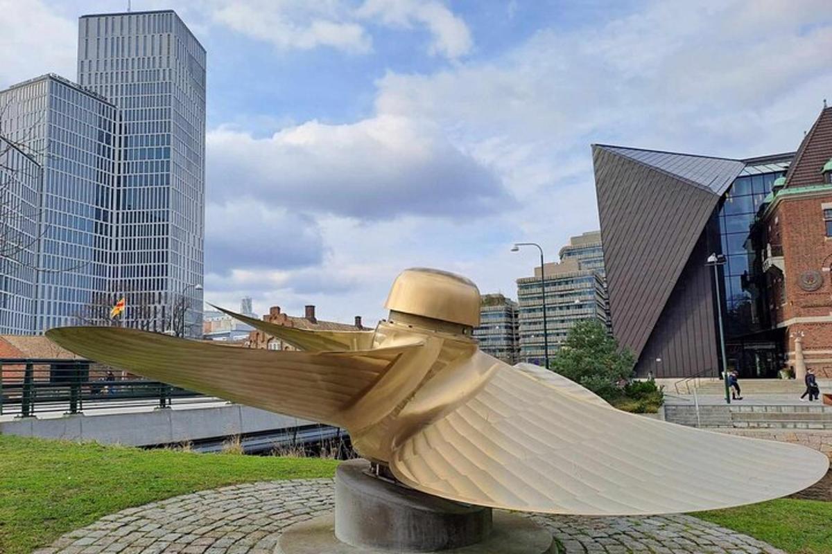 a statue of a bird in a city