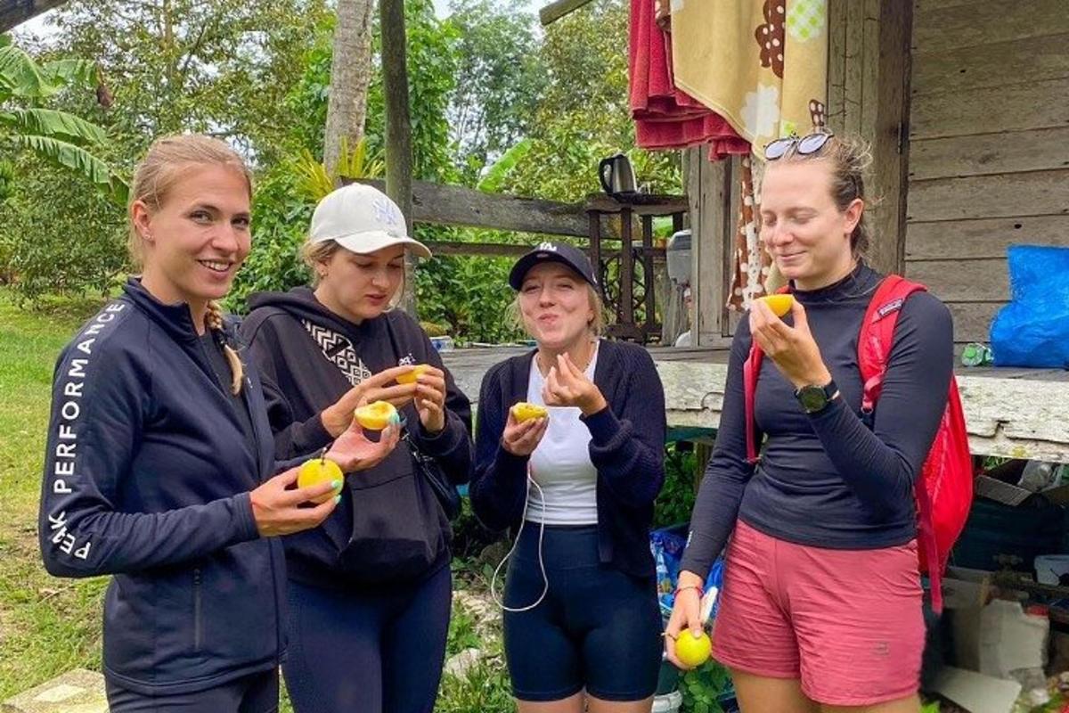 a group of women holding fruit in their hands