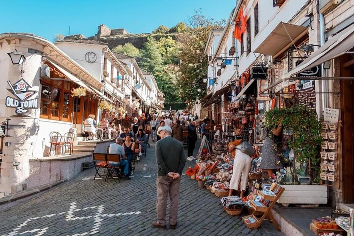 a group of people walking around a street with shops
