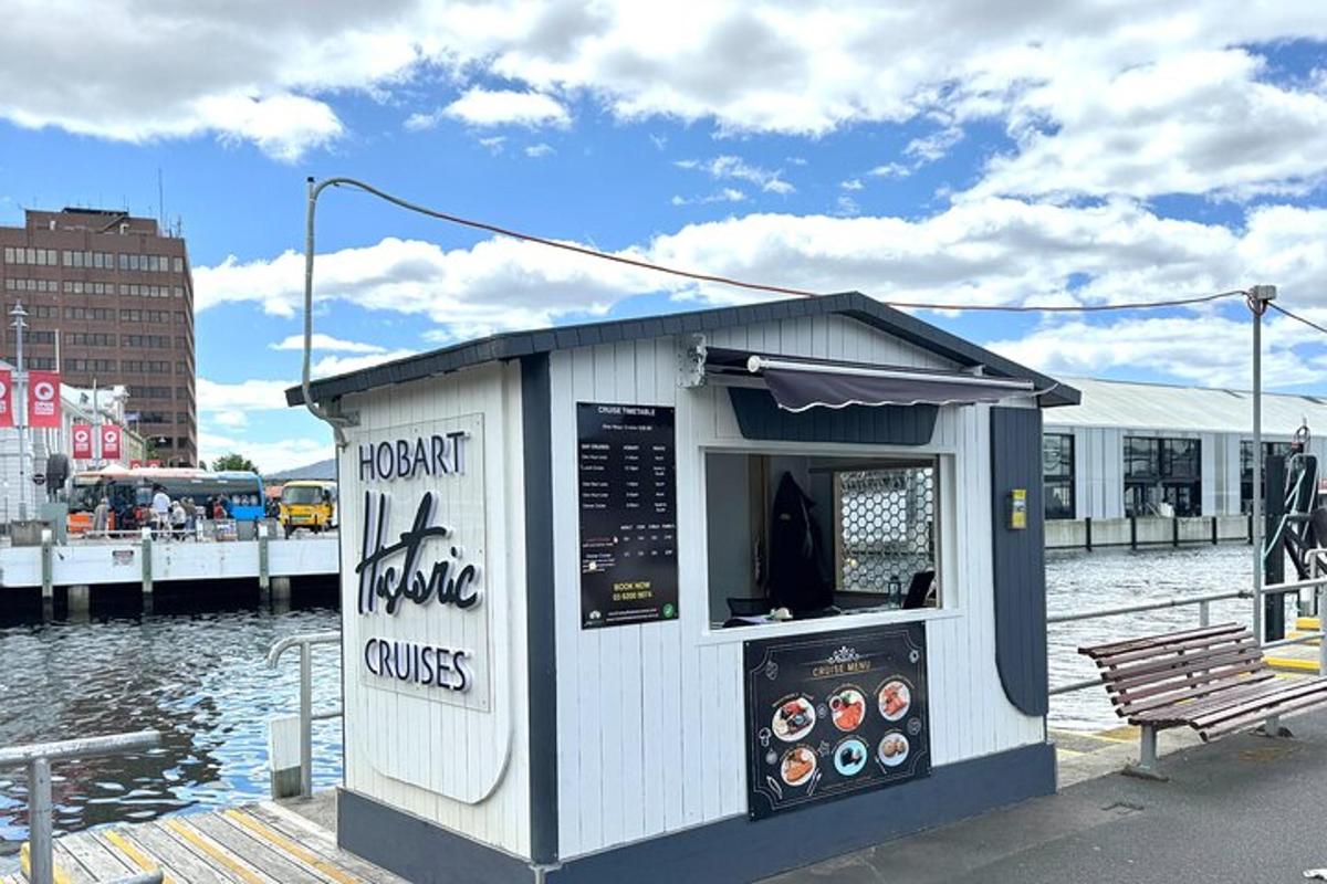 a small kiosk on a pier with a water