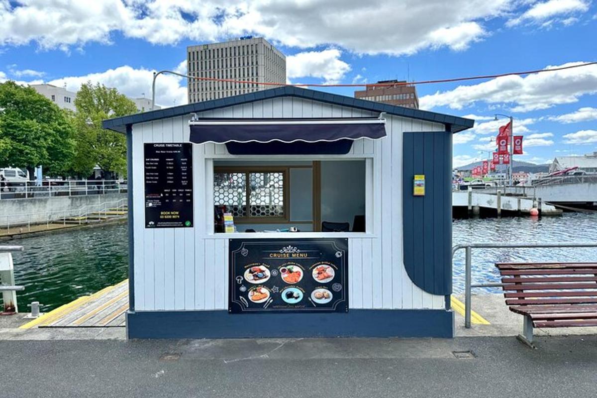 a kiosk on the water with food in it
