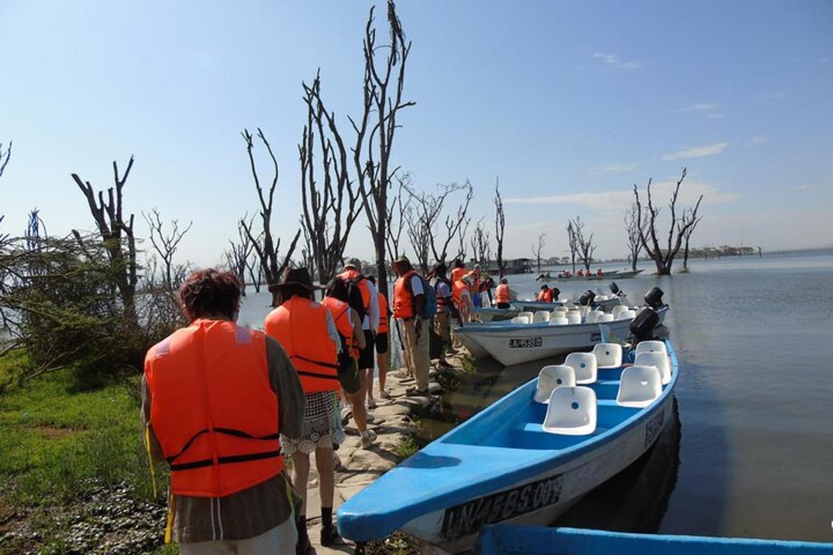 a group of people standing next to boats on the water