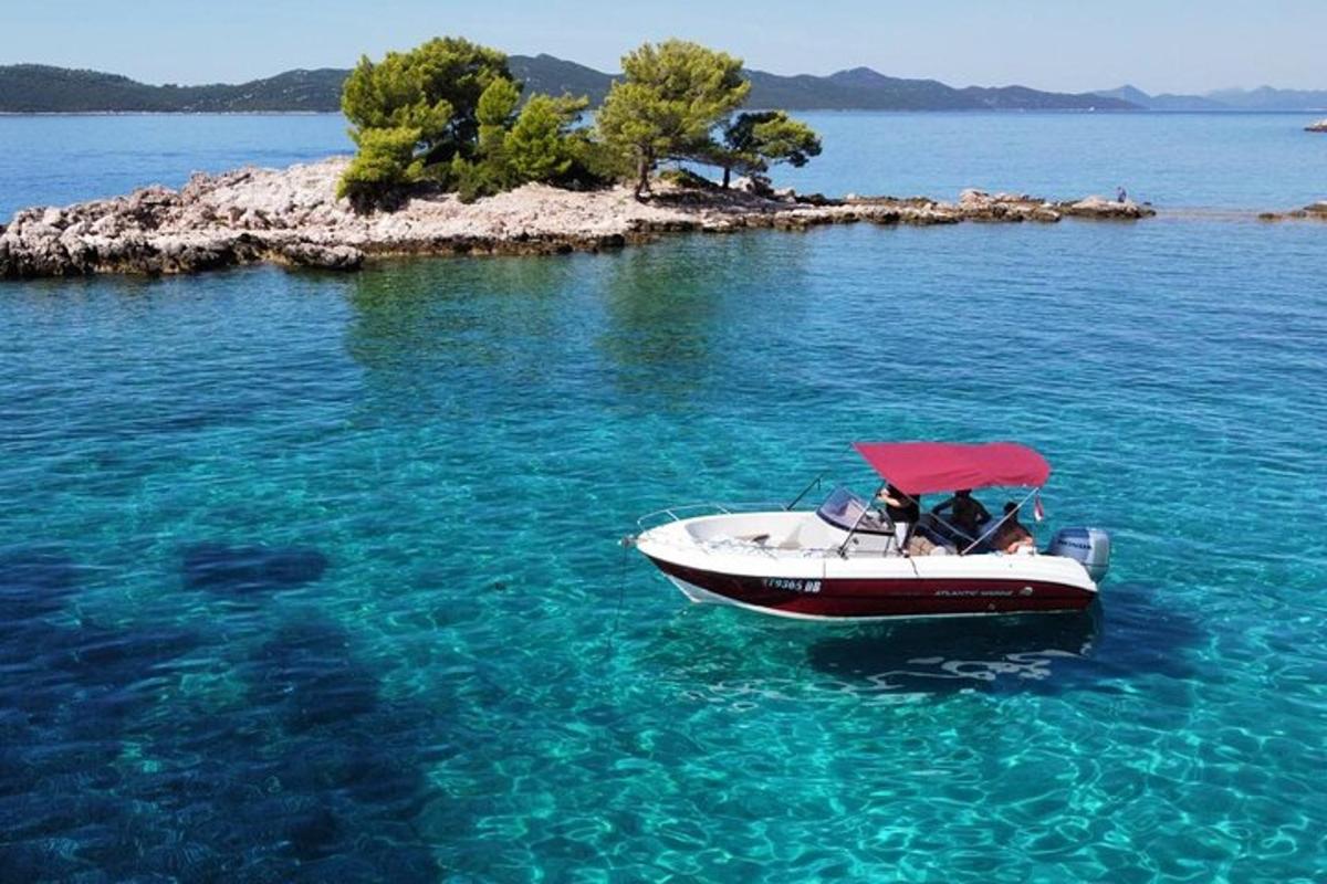 a boat with a red umbrella in the water