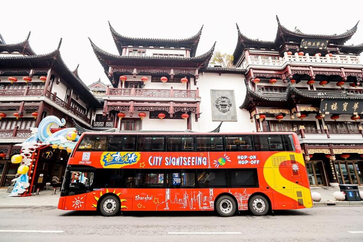 a red double decker bus parked in front of a building