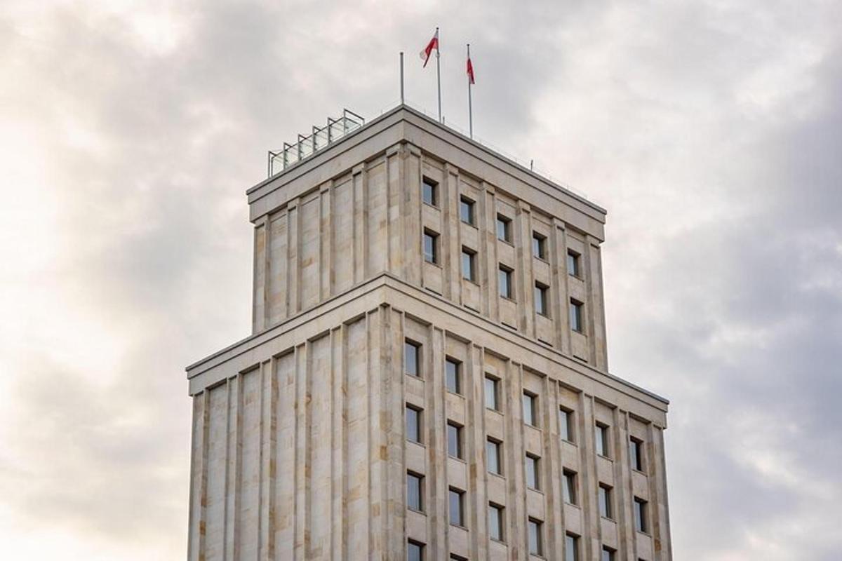 a tall building with two flags on top of it