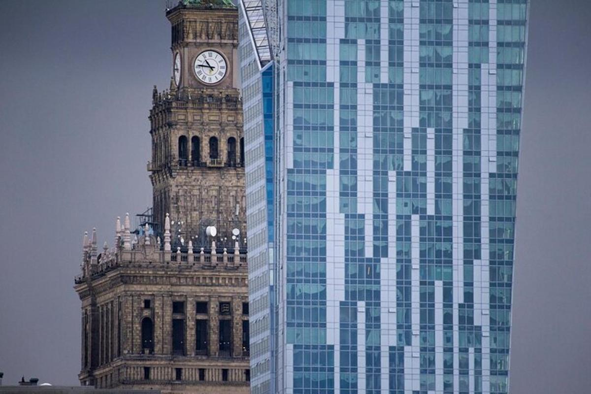 a tall building with a clock tower next to a skyscraper