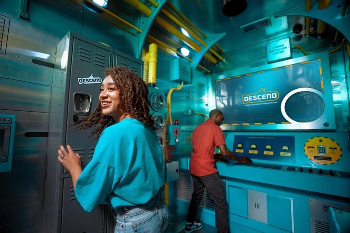 a woman standing inside of a train with a man working