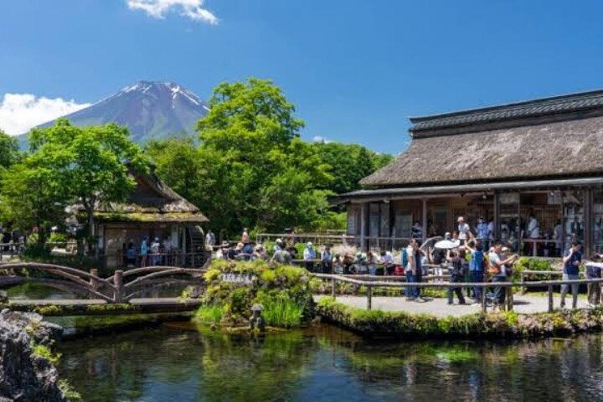 a group of people standing outside a building next to a river