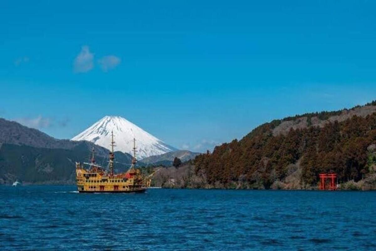 a boat in the water with a mountain in the background