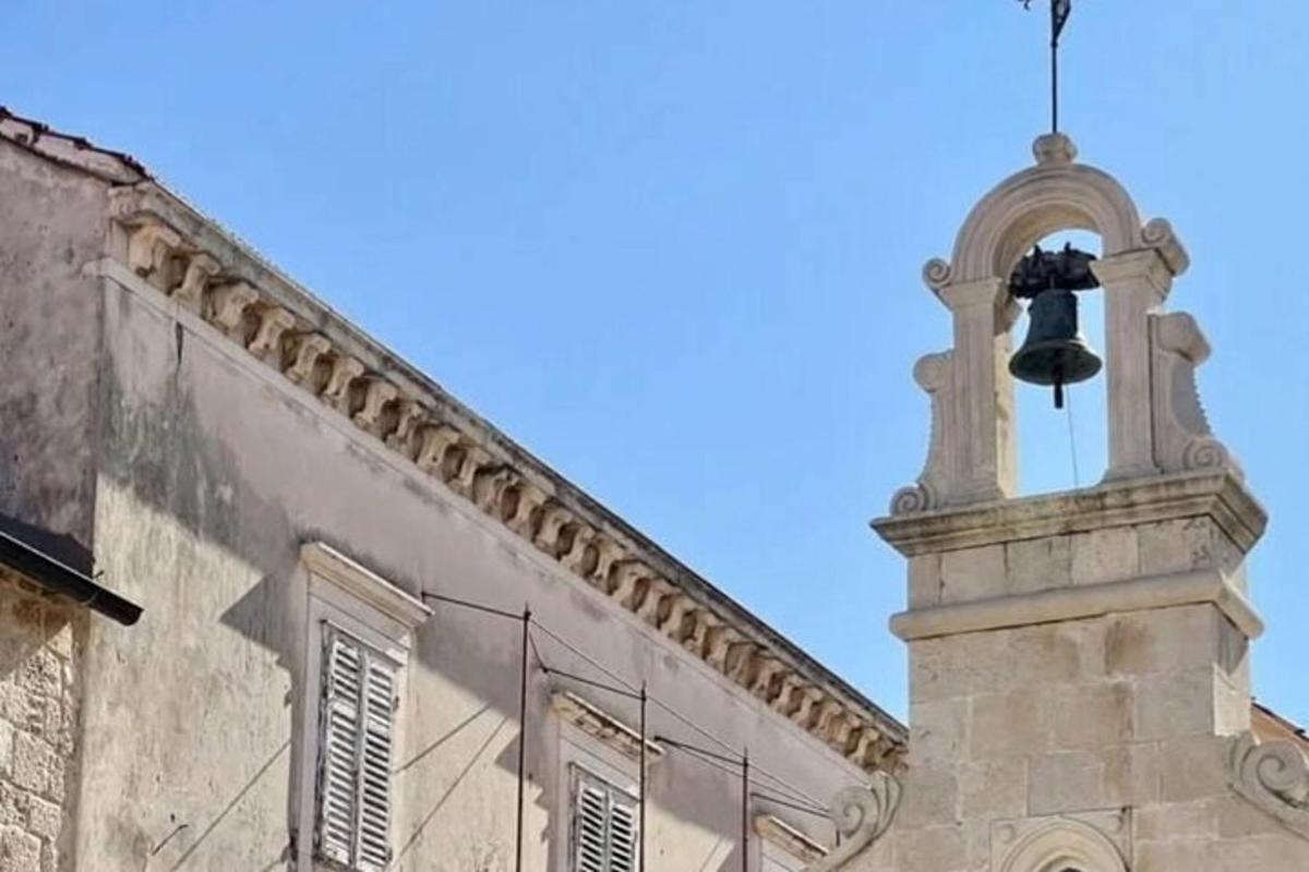a bell tower on the side of a building