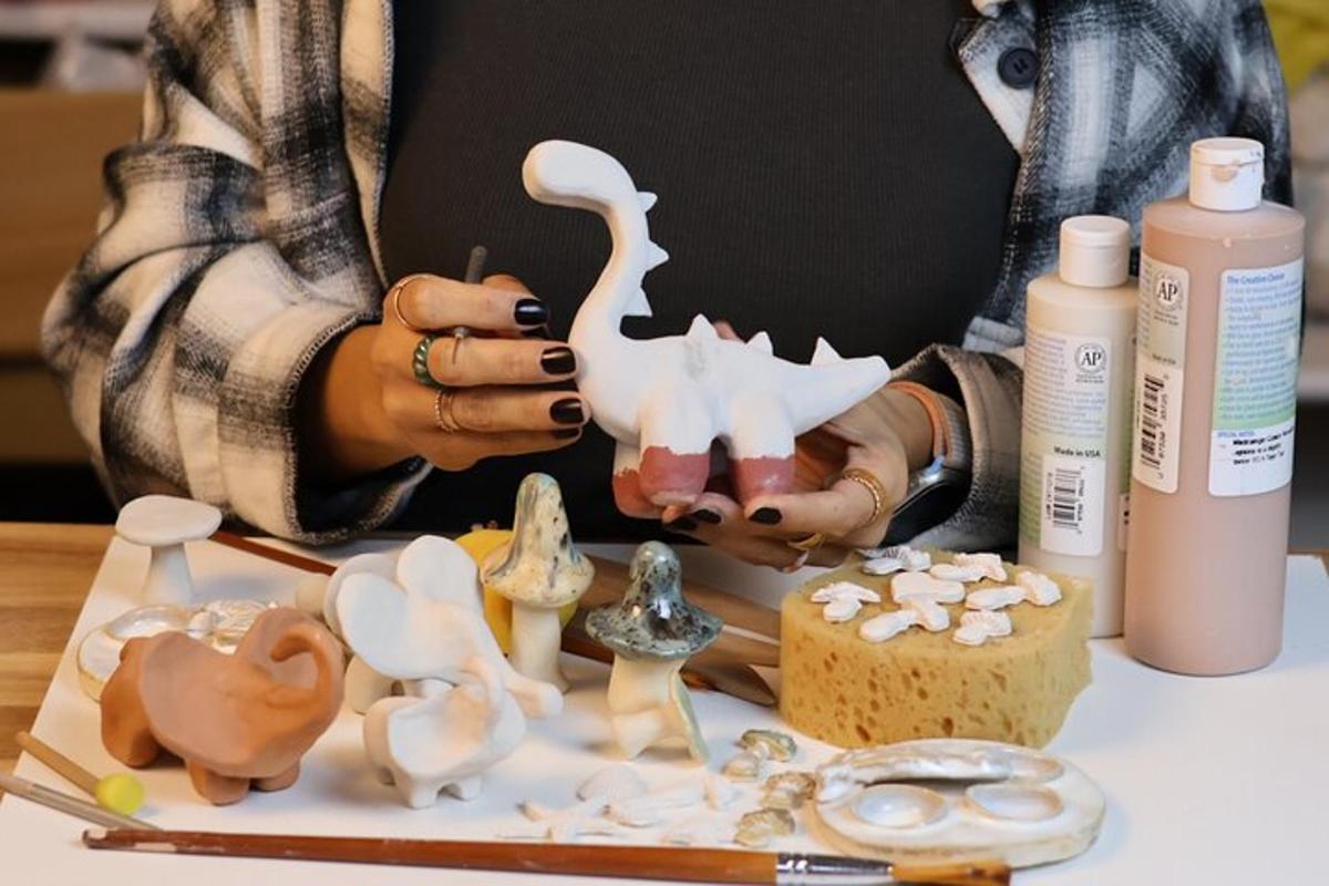 a woman holding a toy dinosaur on a table