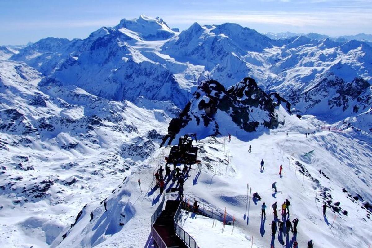a group of people on top of a snow covered mountain