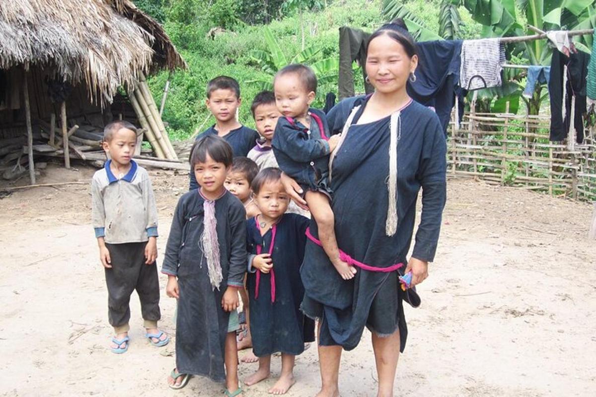 a woman and a group of children standing in a field