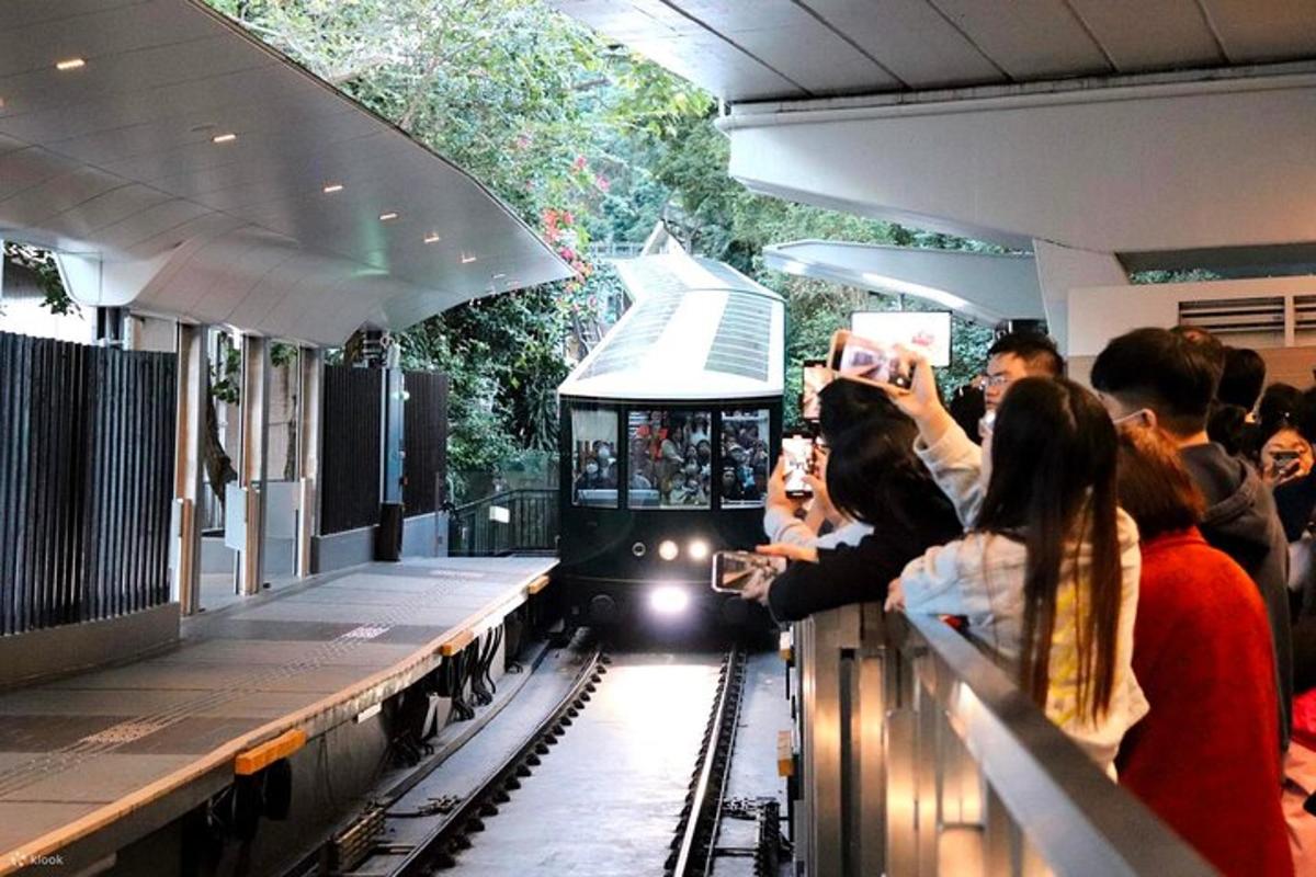 a crowd of people taking pictures of a train