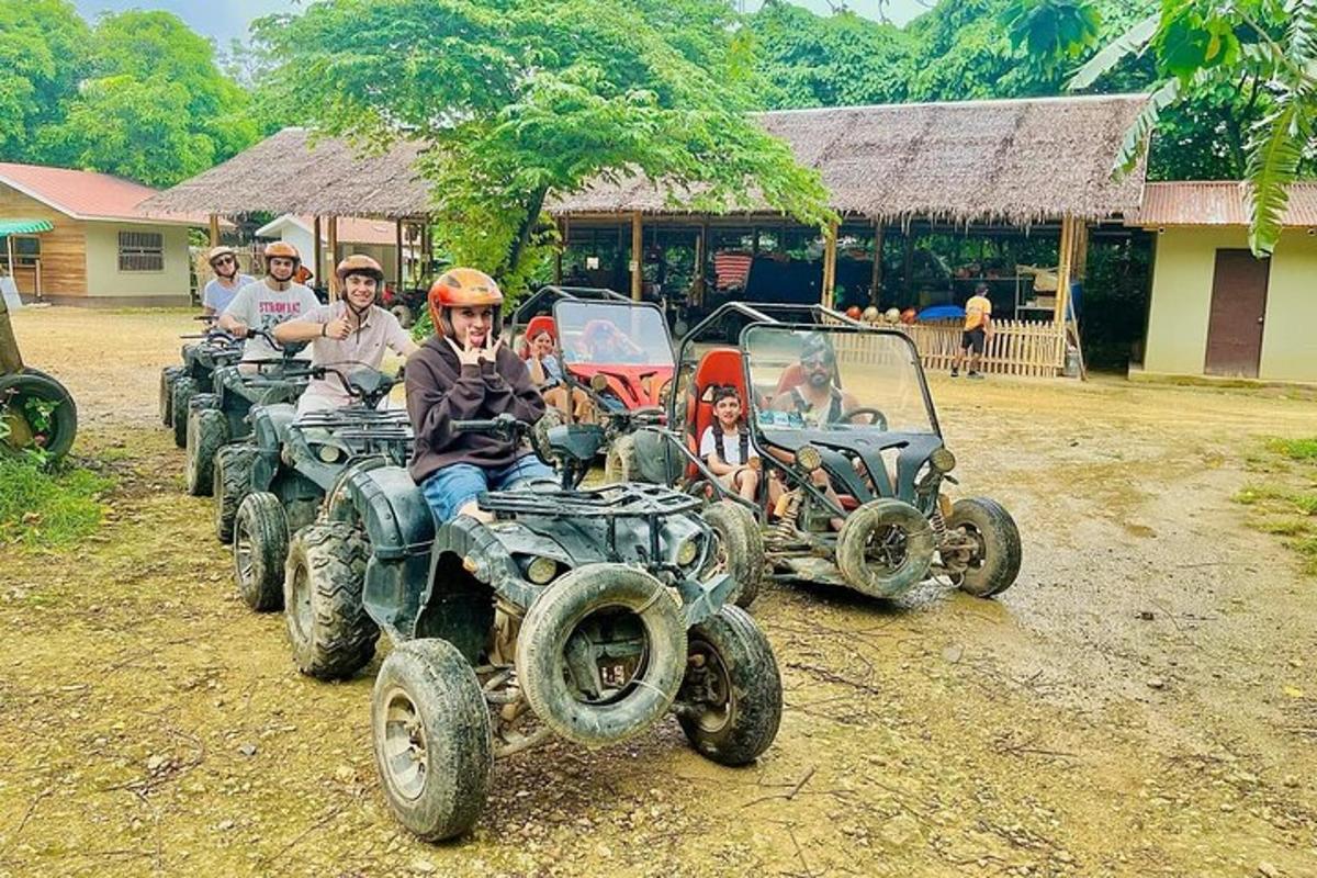 a group of people riding atvs on a dirt field