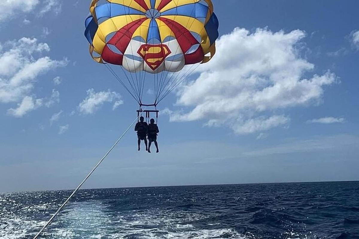 two people on a parachute over the ocean