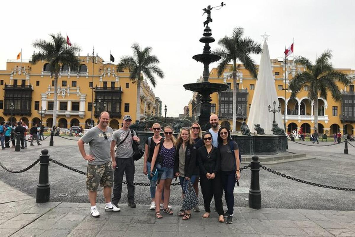 a group of people standing in front of a fountain
