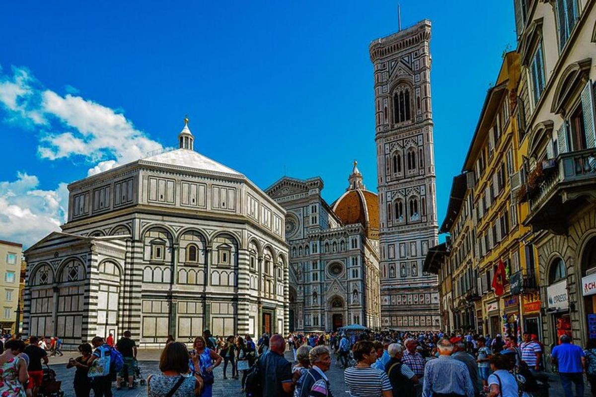 a crowd of people standing in front of a building with a clock tower