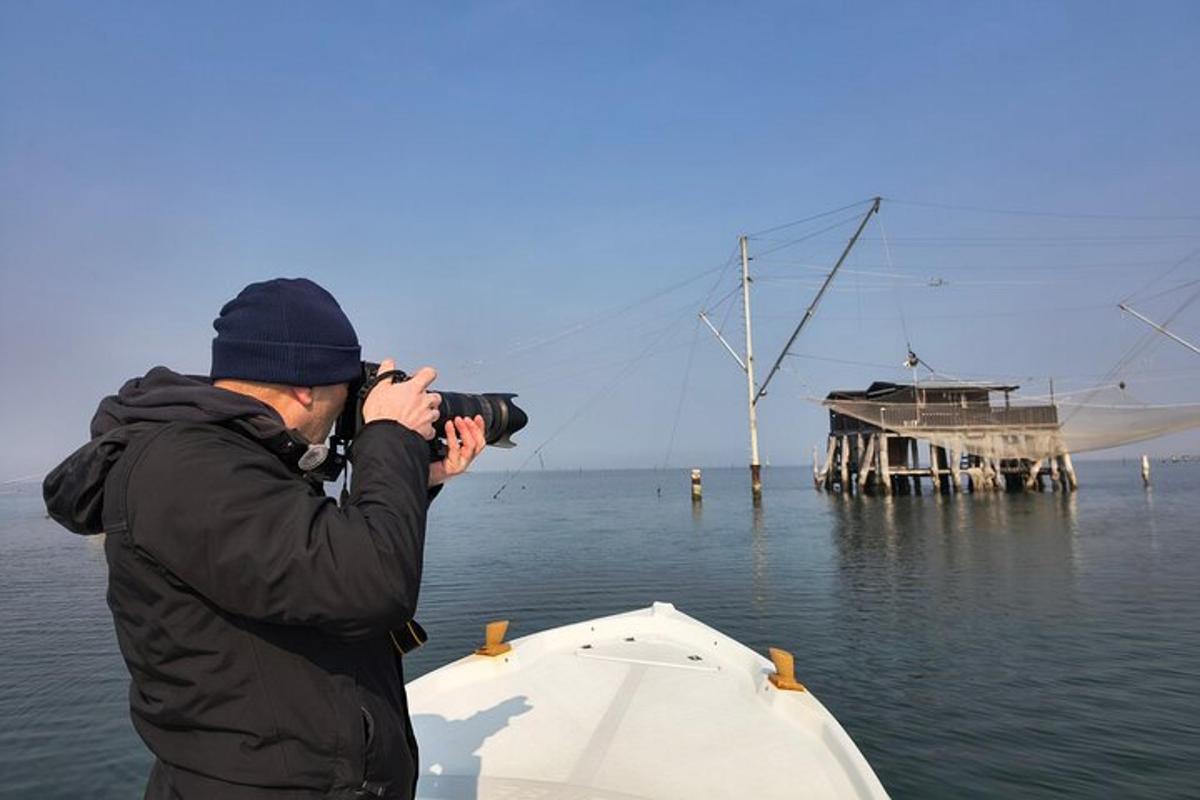 um homem tirando uma foto de um barco na água