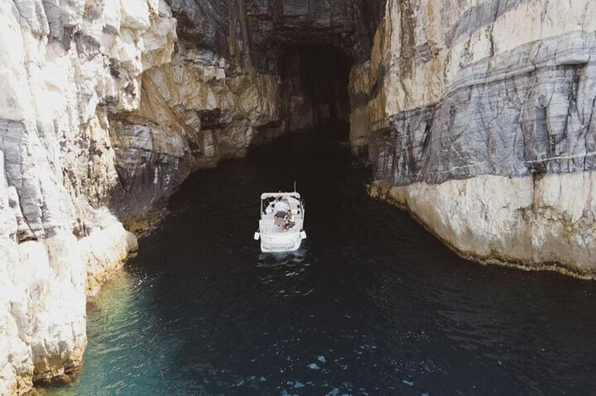 a boat sitting in a cave in the water