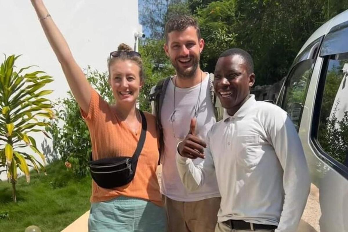 a group of three people standing next to a van