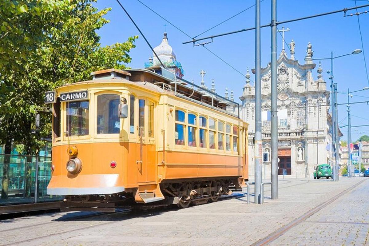 a yellow trolley car on a city street
