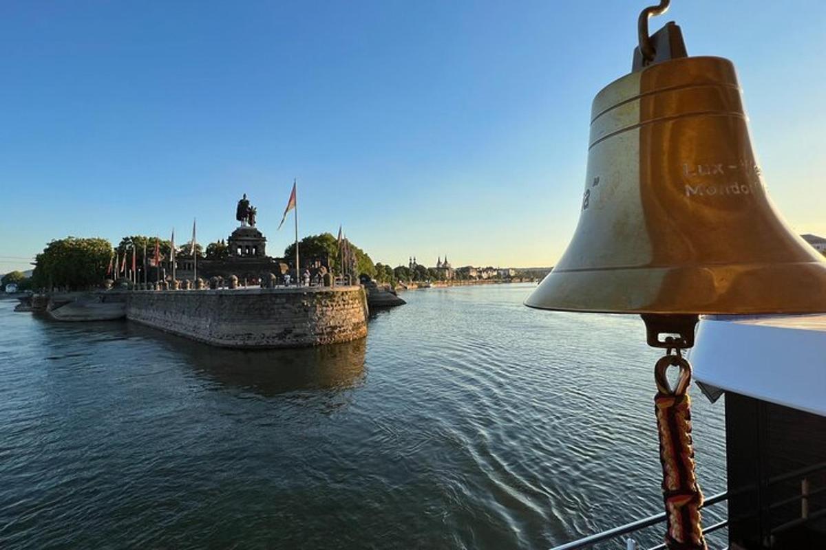 a large bell on the side of a river