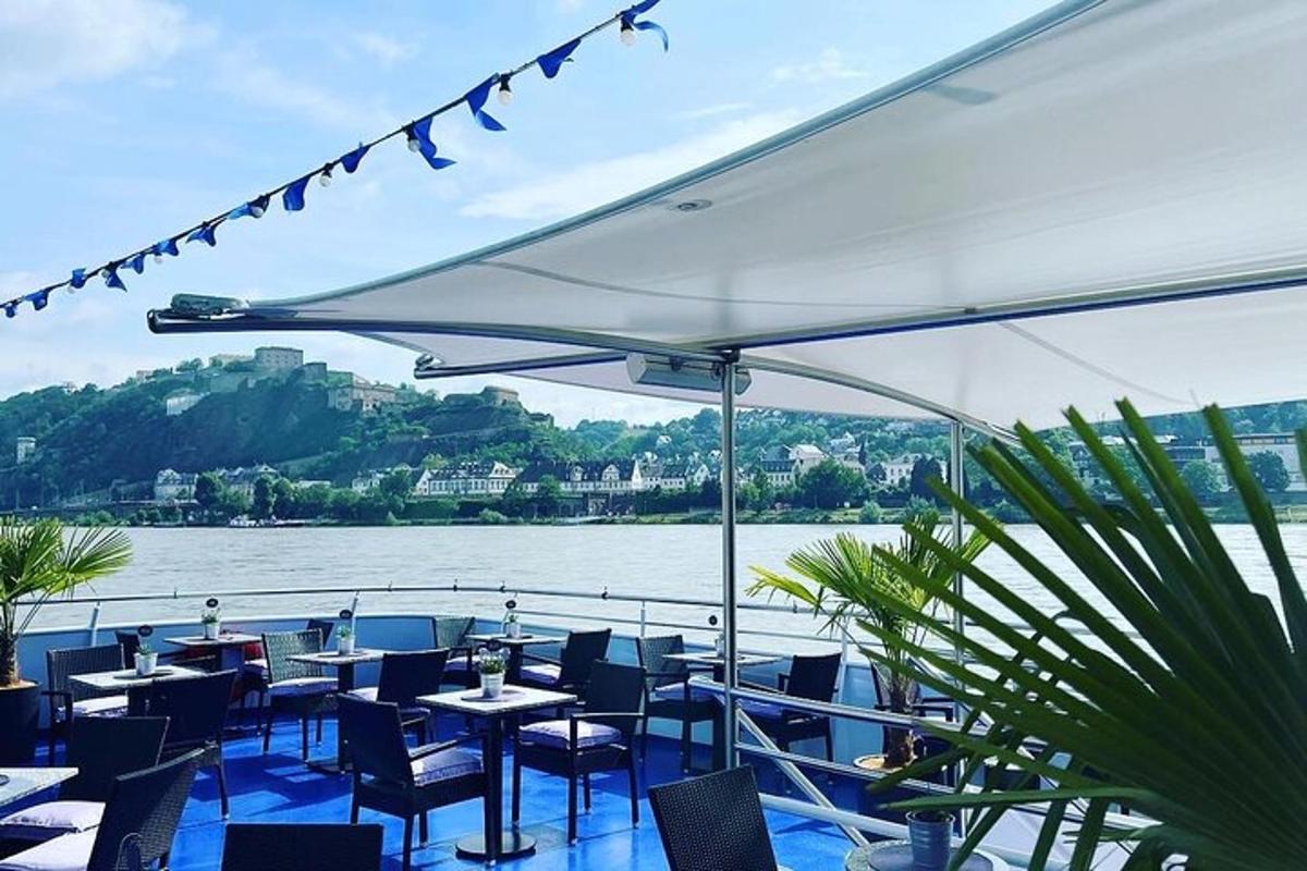 a restaurant with tables and chairs and a view of the water