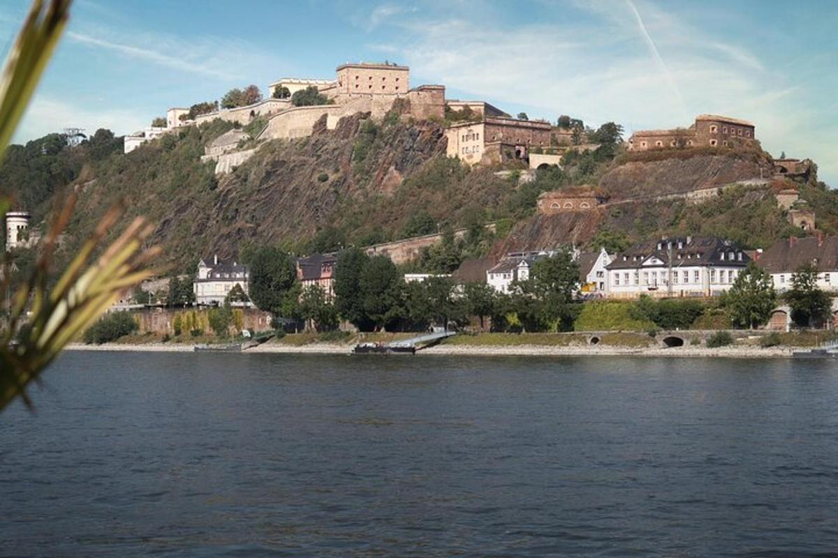 a castle on top of a hill next to a body of water