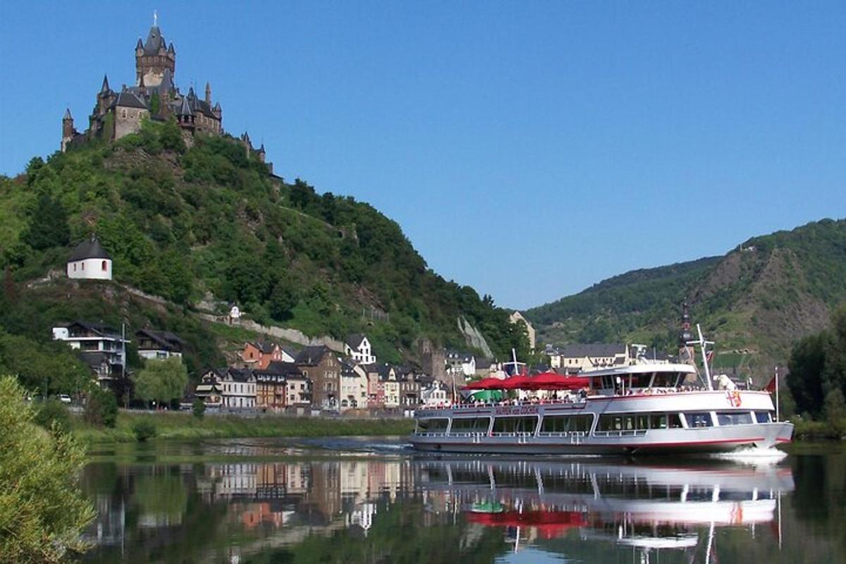 a boat on a river in front of a mountain