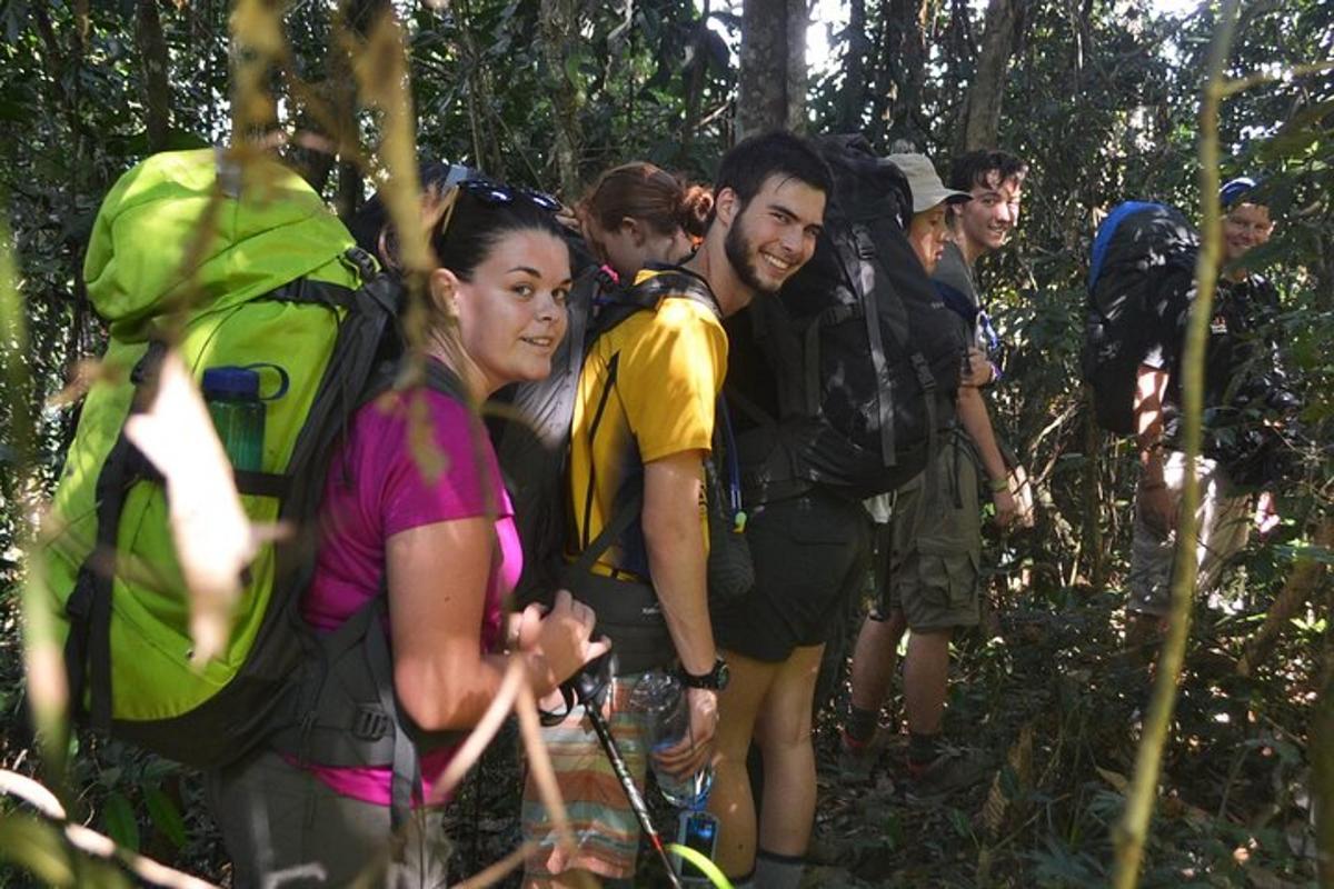 a group of people with backpacks on a trail