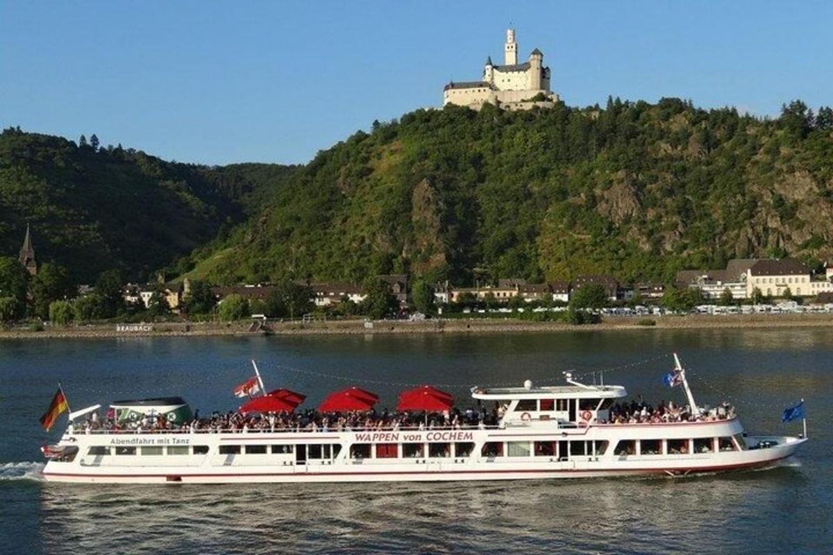 a large white boat with people on it on the water