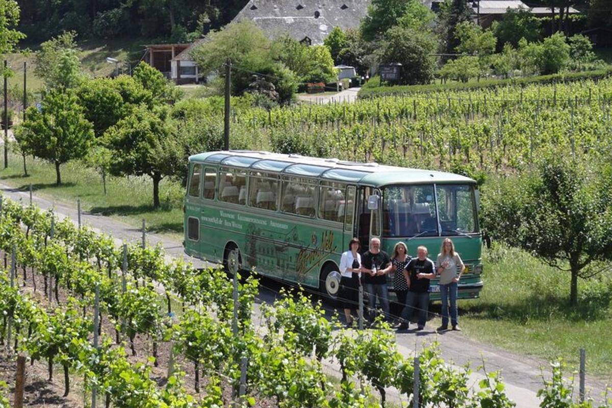 a group of people standing in front of a green bus