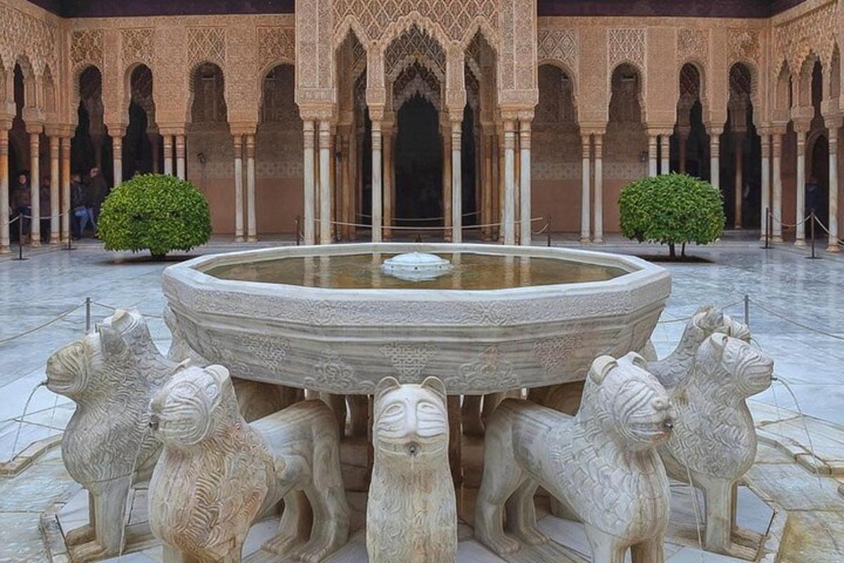a large stone fountain in a building with animals around it