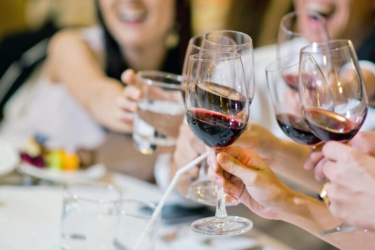 a group of people holding up wine glasses