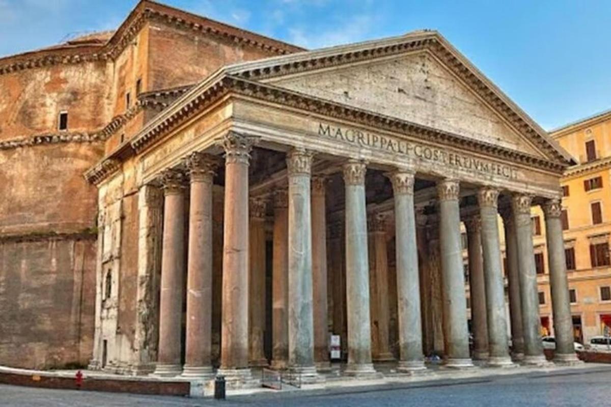 an ancient building with columns in front of a building