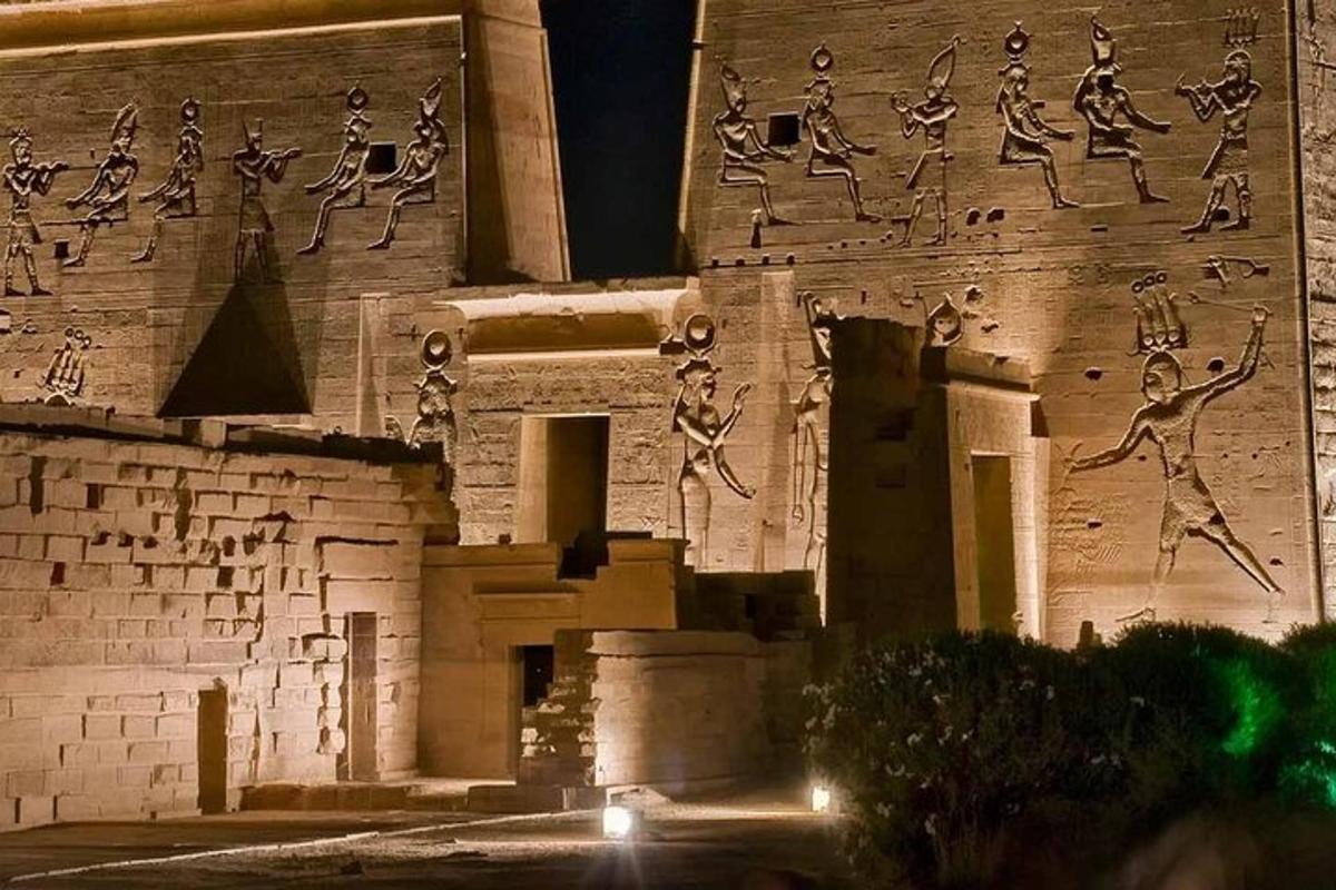 a building with drawings on the side of it at night