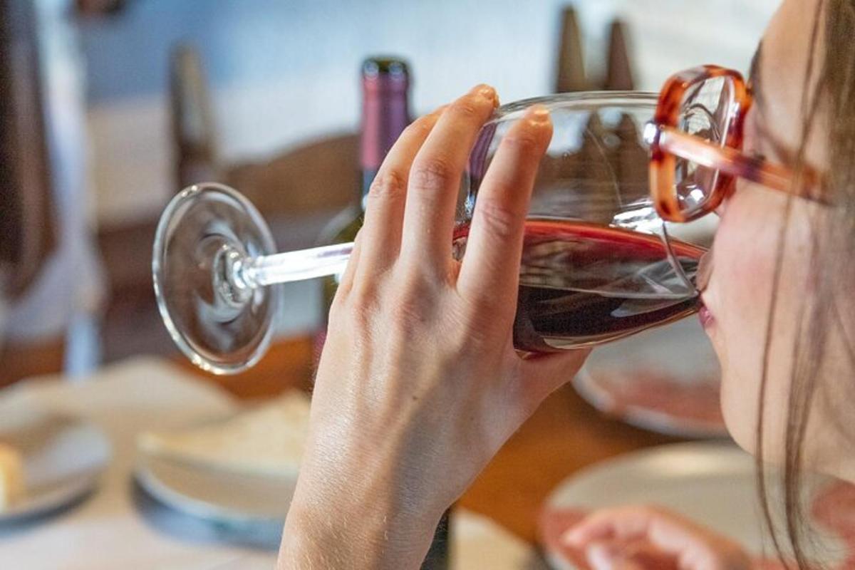a woman drinking from a glass of wine