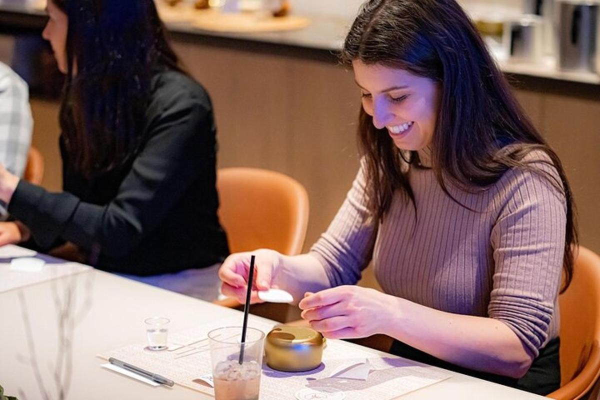 a woman sitting at a table with a candle