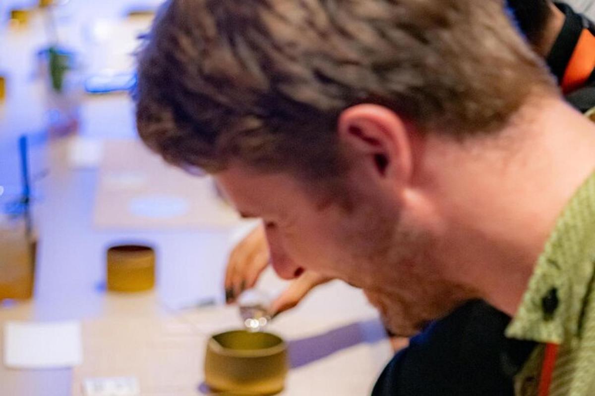 a man is drinking from a wine glass