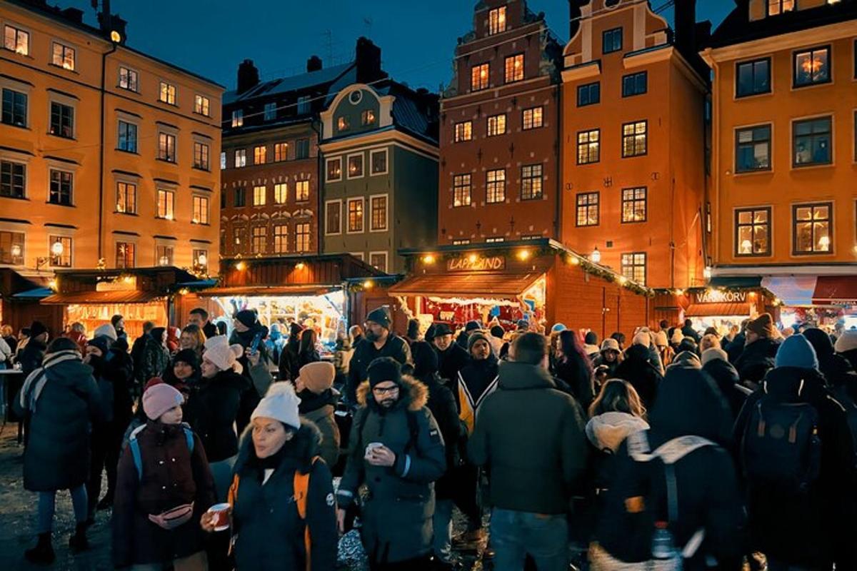 a crowd of people walking around a christmas market